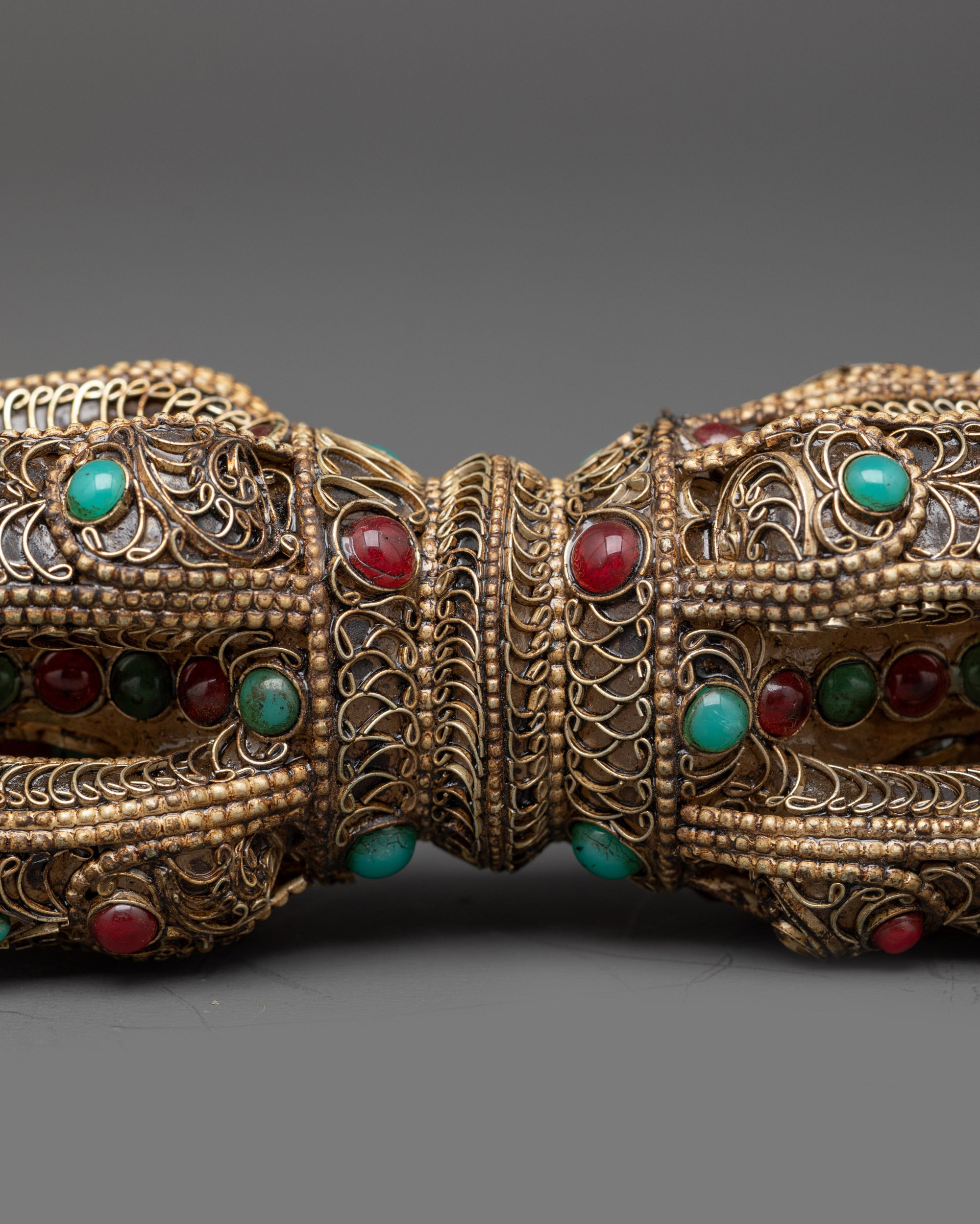 Close up copper filigree design on handcrafted double-ended Vajra Dorje
