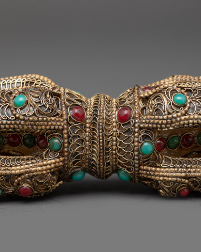 Close up copper filigree design on handcrafted double-ended Vajra Dorje