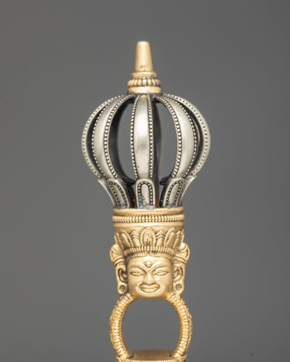 Close up copper handle bell with deity carving Himalayan ritual instrument