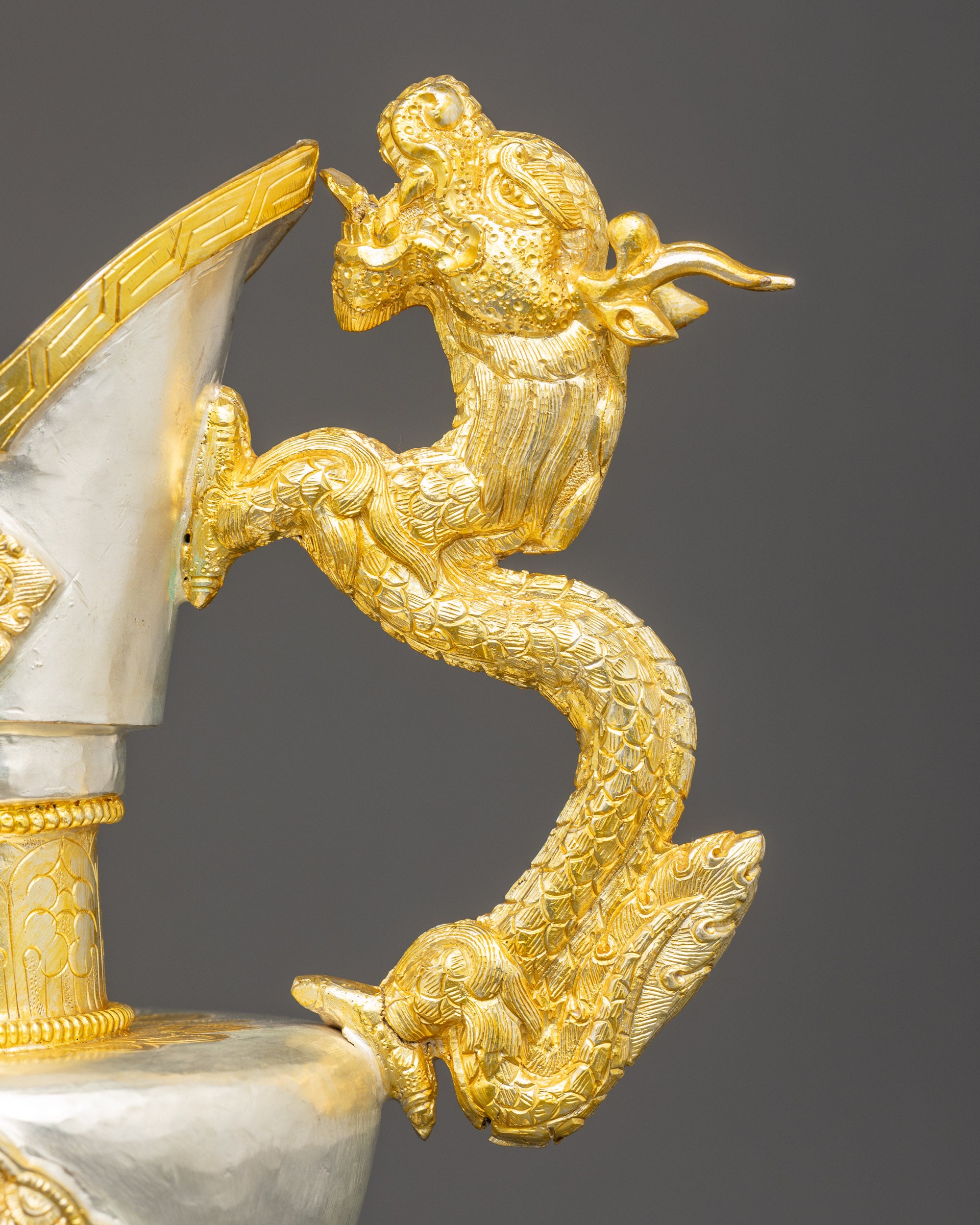 Close up dragon handle Bumba showing gold silver plated copper and detailed Himalayan craftsmanship