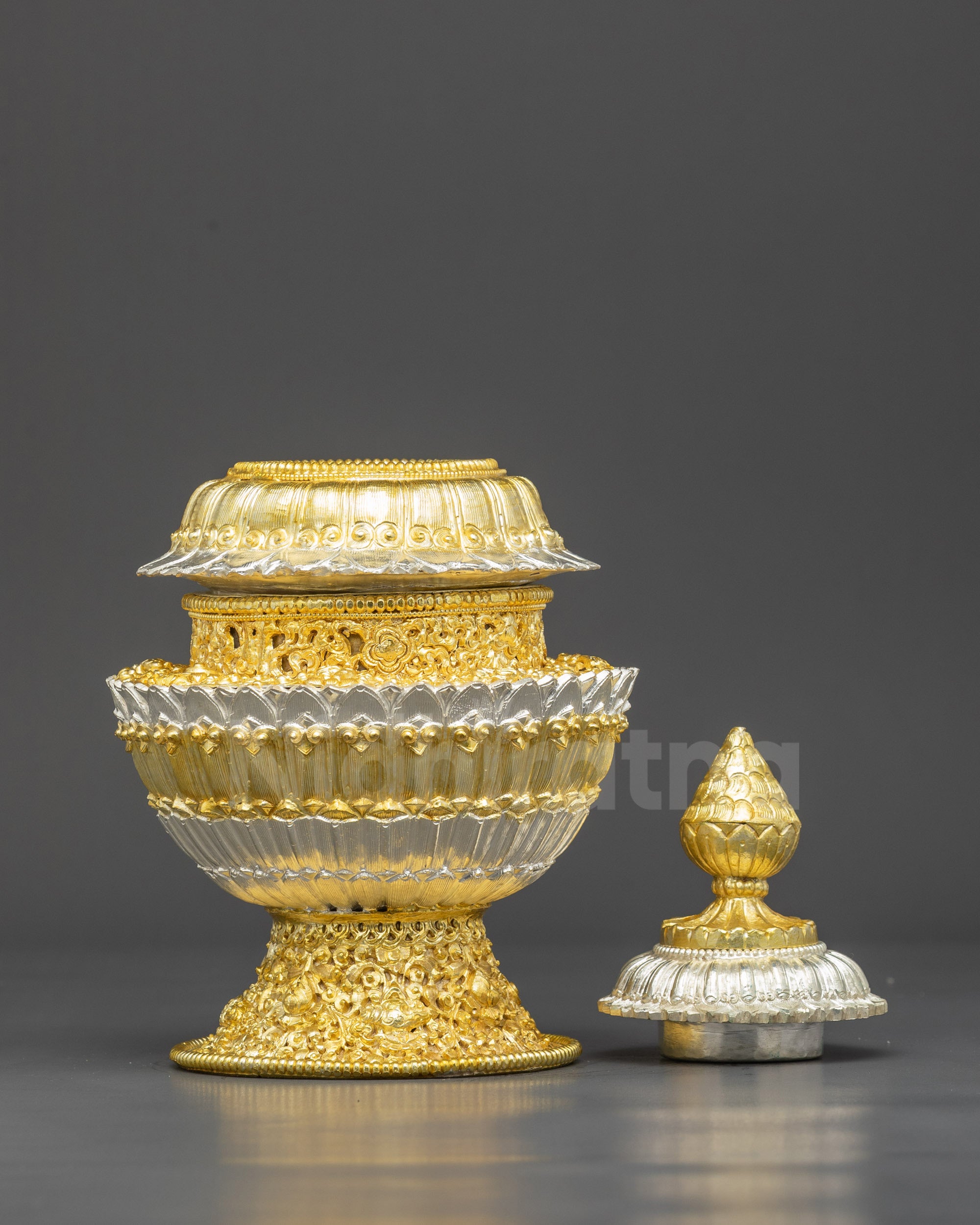 Close up floral design on Himalayan copper rice pot with gold silver finish