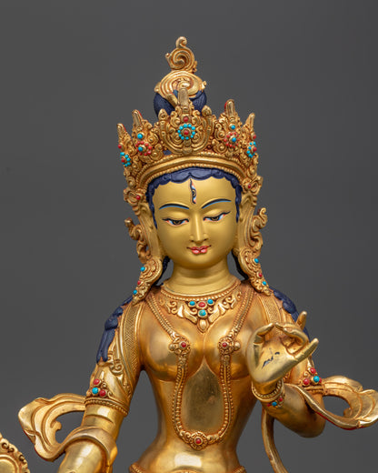 Close up gold-gilded face Dukar Statue with third eye and jeweled crown
