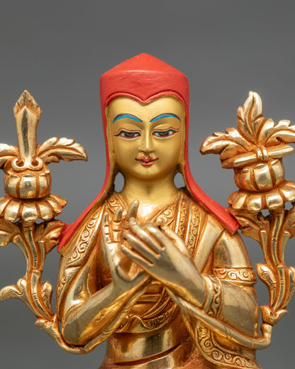 Close up gold-painted face Abhaya Mudra Himalayan art sculpture