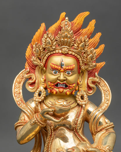 Close up gold-painted face Black Dzambhala wrathful guardian of abundance