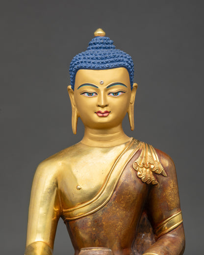 Close up gold-painted face Shakyamuni Buddha with hand-painted details