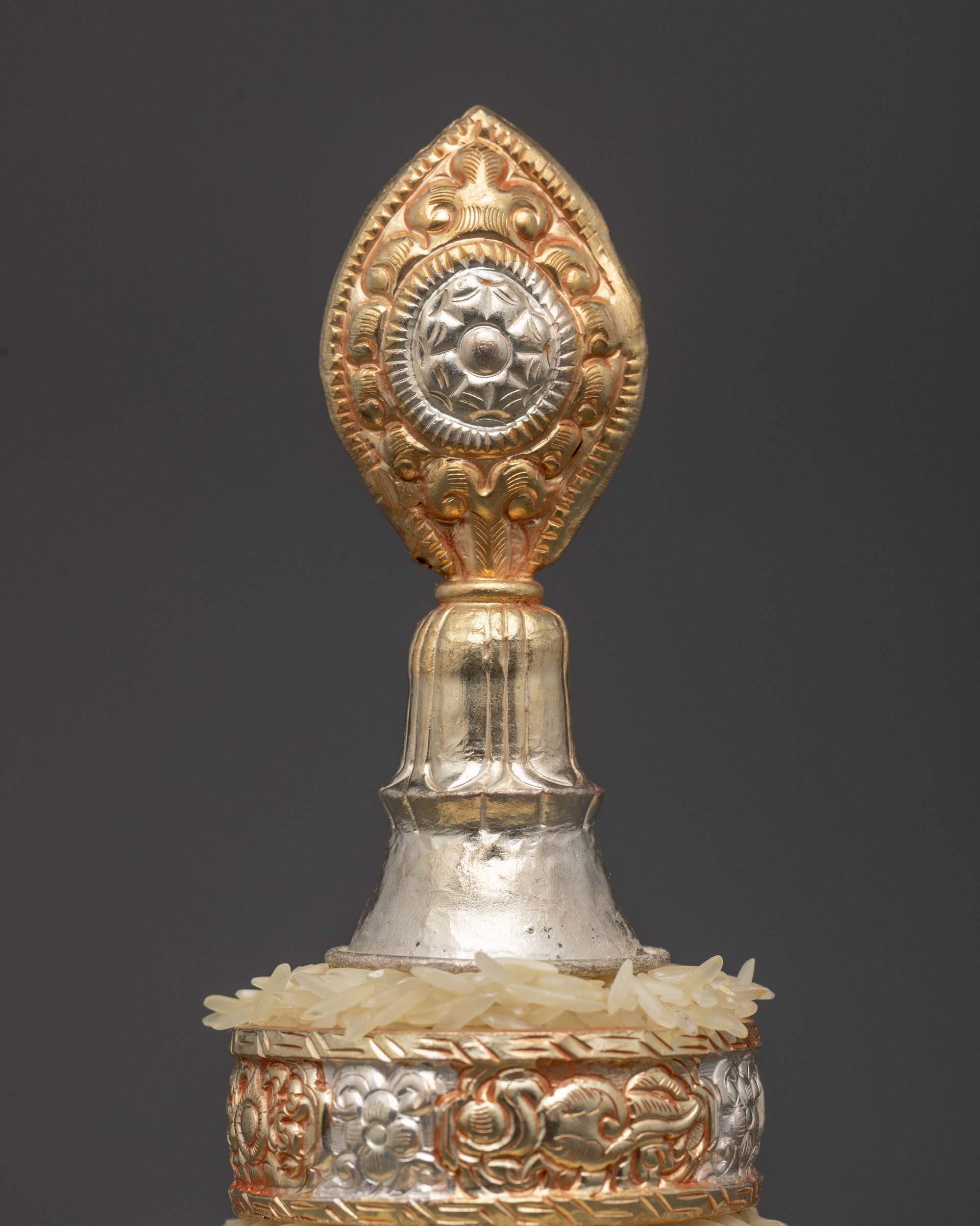 Close up intricate gold-plated Ratna Mandala Offering with tiered design, sacred offering vessel for Vajrayana Buddhist practice