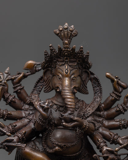 Close up of 12 Armed Ganesha showing five-jeweled crown and sacred objects in hands