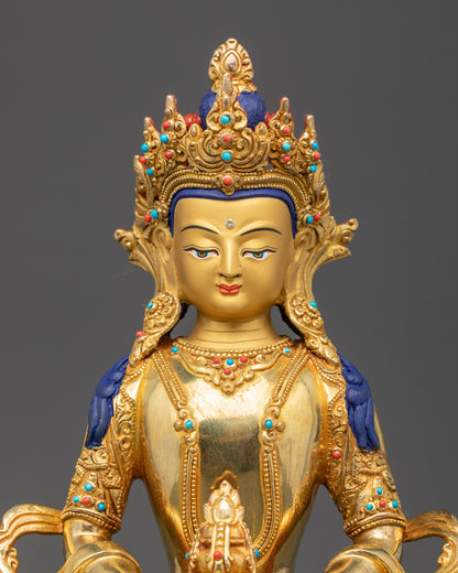 Close up of Amitayus Buddha gold-gilded face and intricate crown with semi-precious stones
