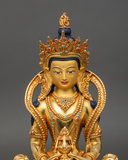 Close up of Amitayus Buddha’s serene face with gold detailing and semi-precious stones