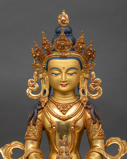 Close up of Amitayus statue showing gold gilding and serene Himalayan craftsmanship