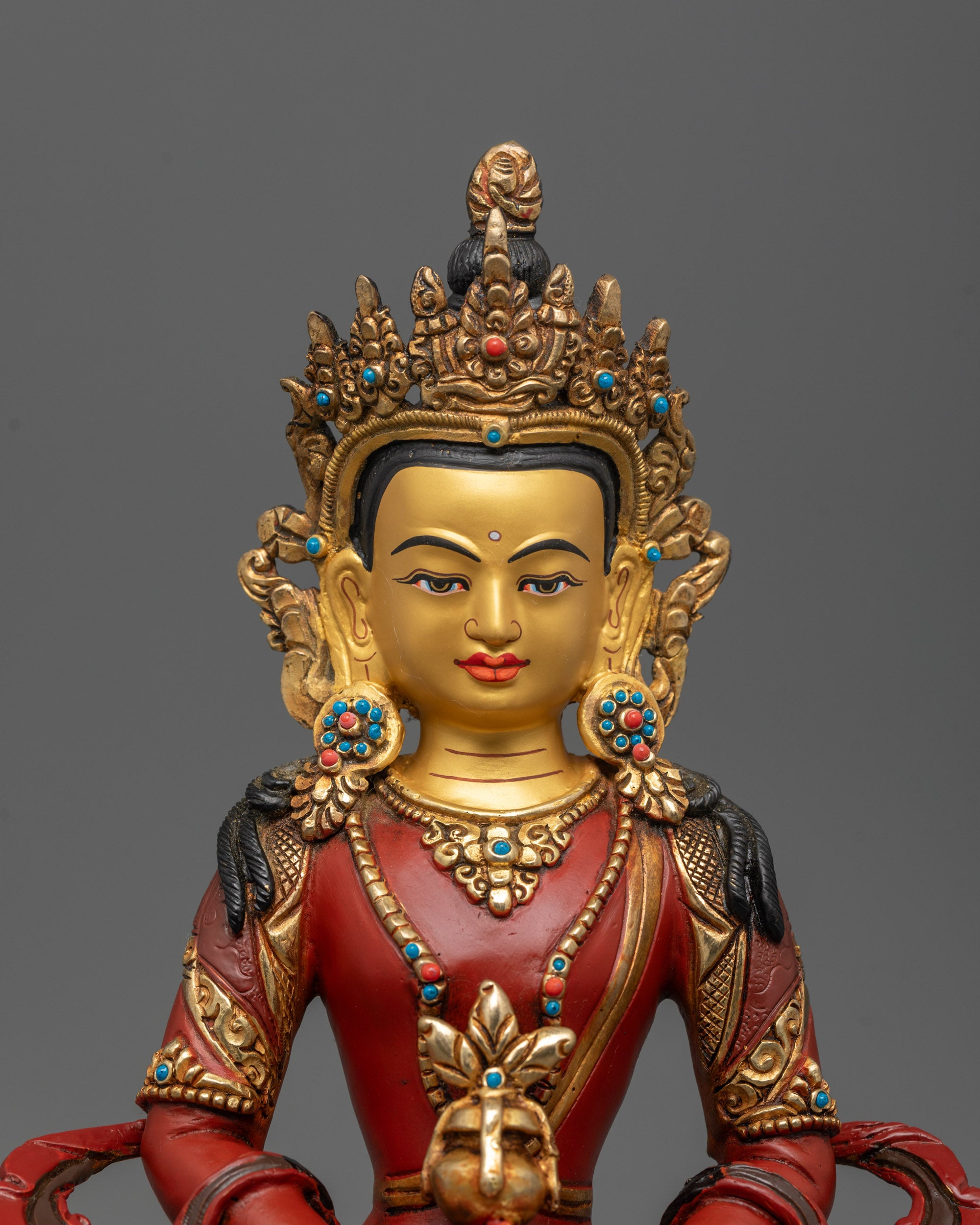 Close up of Amitayus statue showing semi-precious stone-adorned crown and robe details