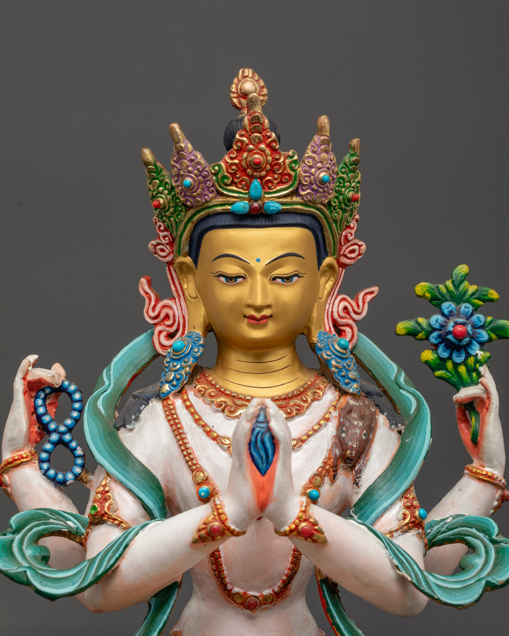 Close up of Avalokiteshvara statue showing crystal rosary, lotus, and wish-fulfilling gem
