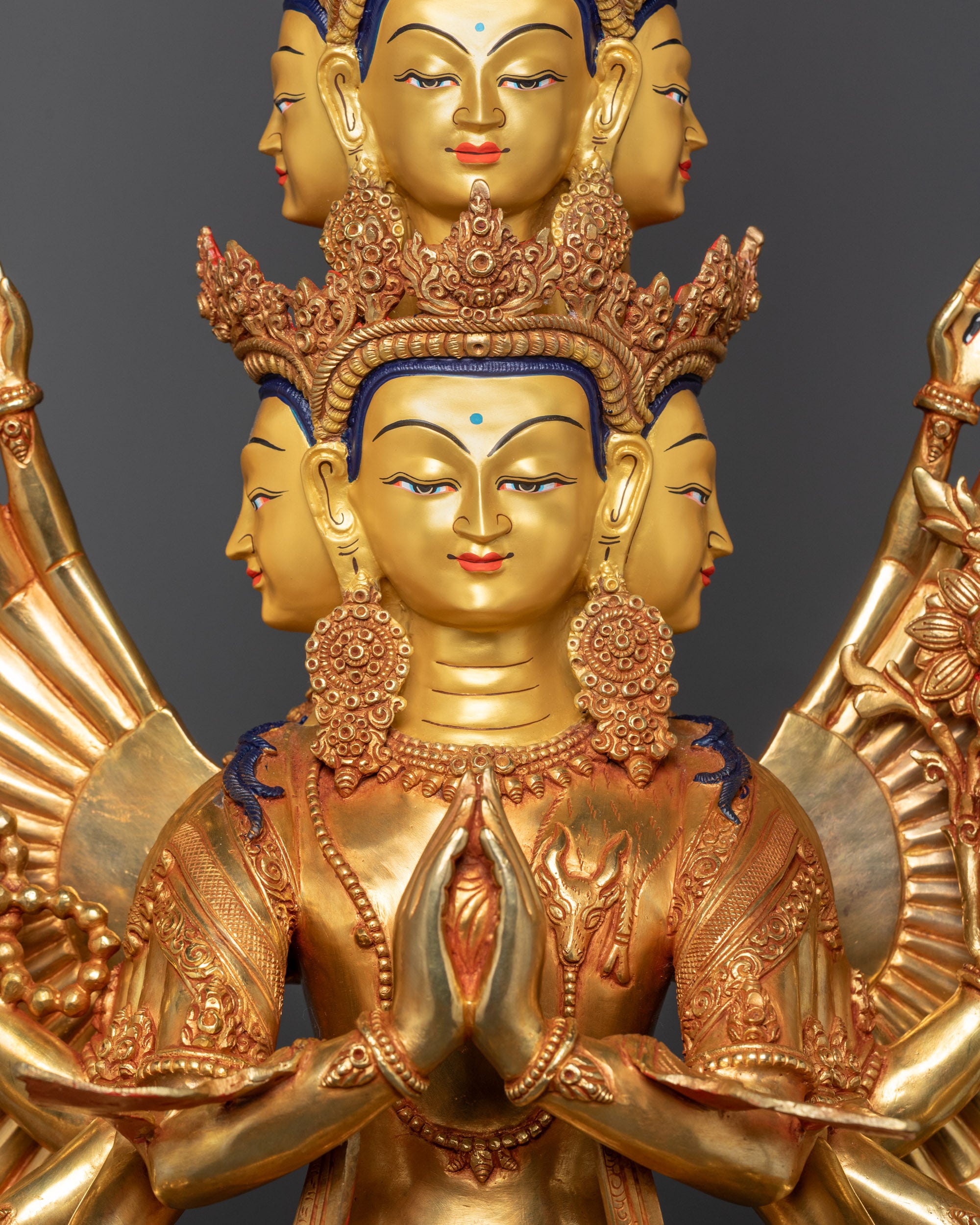 Close up of Avalokiteshvara statue showing detailed arms, eyes on palms, and crown patterns