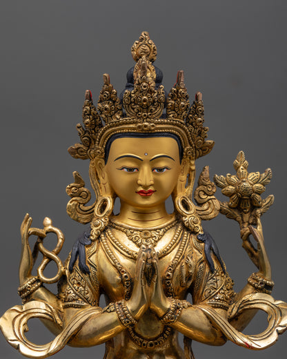 Close up of Avalokiteshvara statue showing four arms holding jewel, mala, and lotus flower