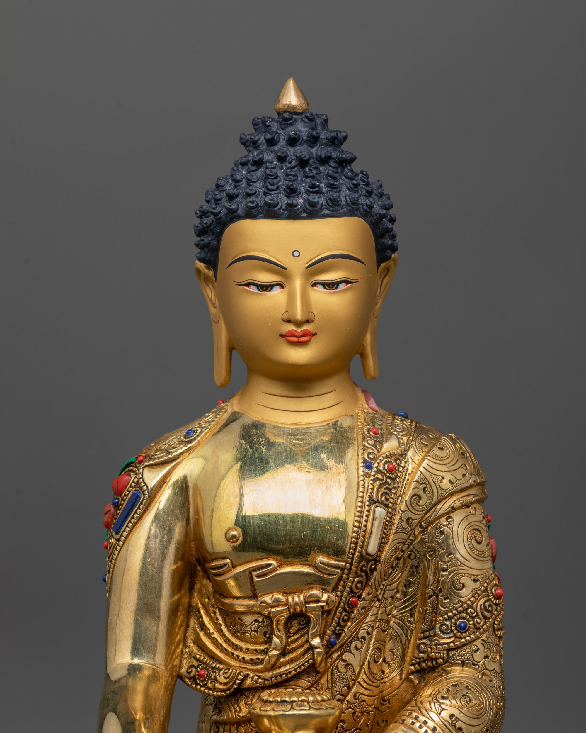 Close up of Buddha Shakyamuni Statue showing intricate carved monk’s robe and halo details