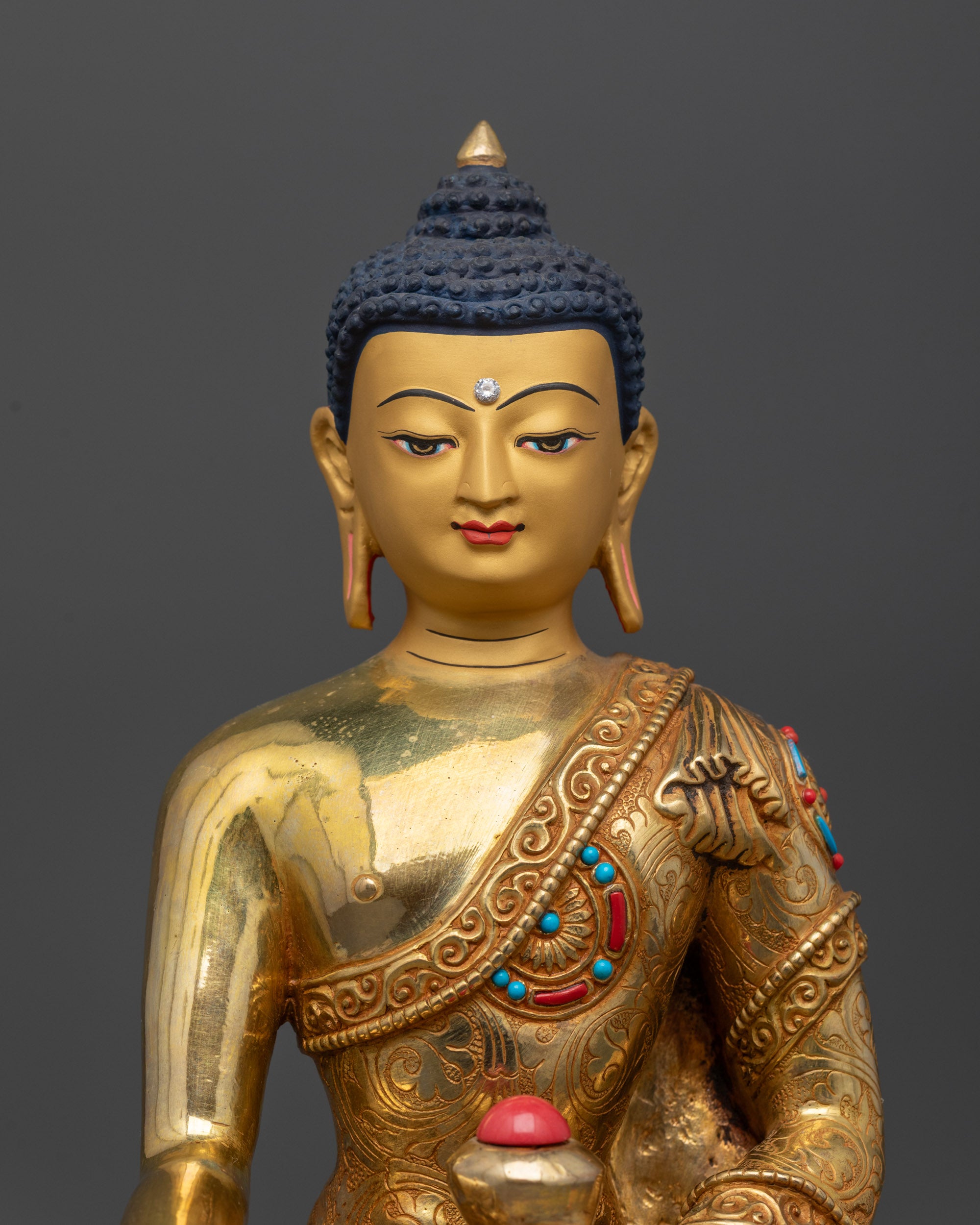 Close up of Buddha Shakyamuni meditating sculpture showing intricate robe and halo details