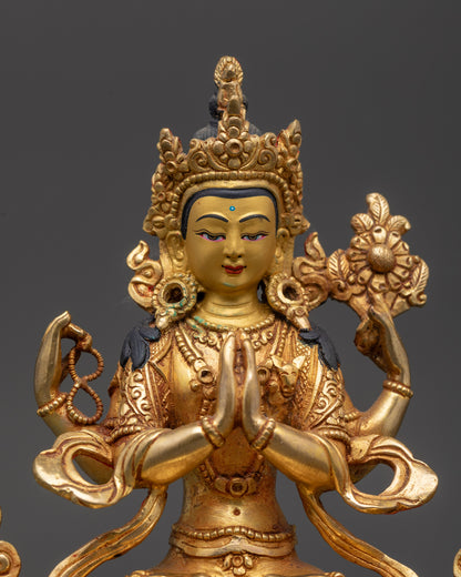 Close up of Chenrezig Statue face and four arms with lotus, beads, and jewel
