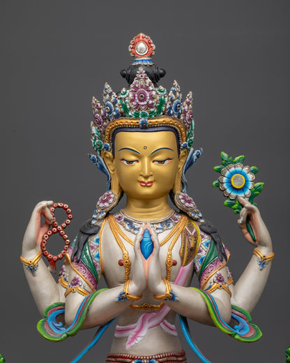 Close up of Chenrezig Statue showing painted robes and lotus throne details