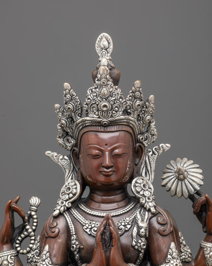 Close up of Chenrezig’s crown and jewelry with silver plating on oxidized copper texture