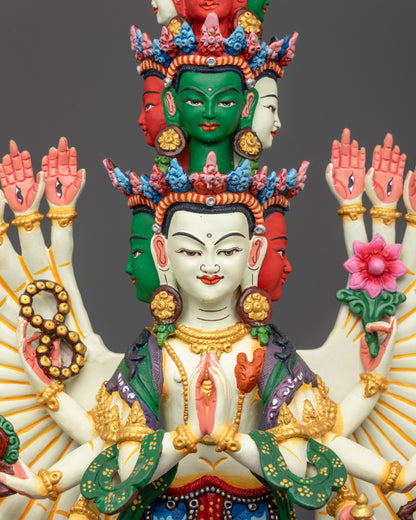 Close up of Chenrezig’s hands holding jewel, rosary, dharma wheel, lotus, and bow