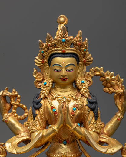 Close up of Chenrezig statue showing crown, jewelry, and serene facial expression

