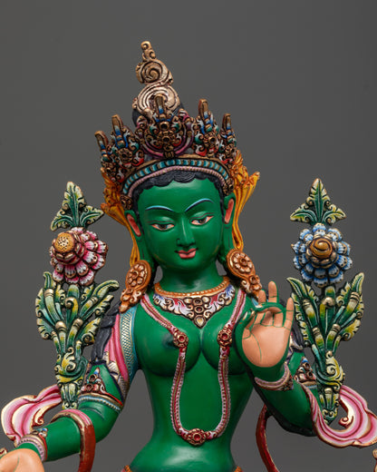 Close up of Coloured Green Tara holding utpala flower in Varada mudra with vibrant colors
