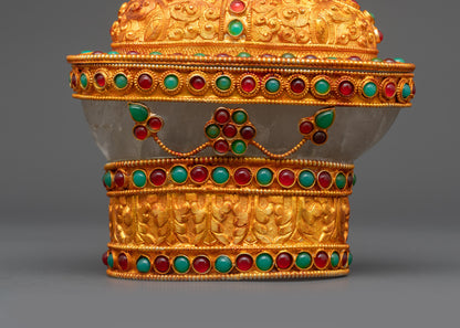 Close up of Crystal Kapala adorned with ruby emerald gemstones and carved motifs