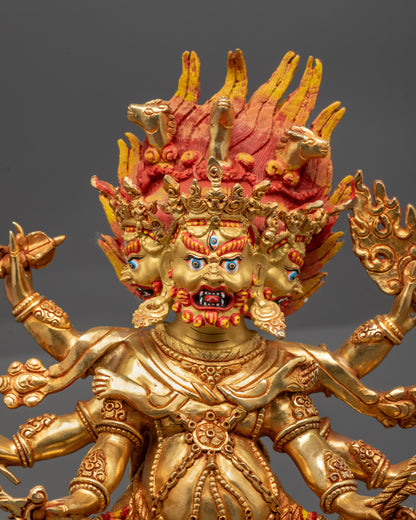 Close up of Dharmapala Sculpture showing expressive face and detailed sacred ornaments

