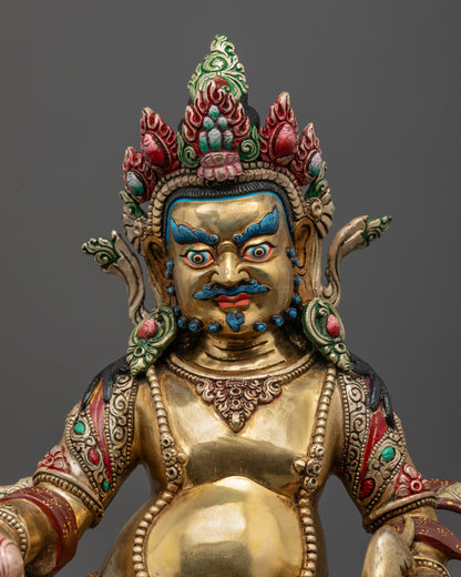 Close up of Dzambhala statue showing vibrant shell crown, jewelry, and semi-precious stones
