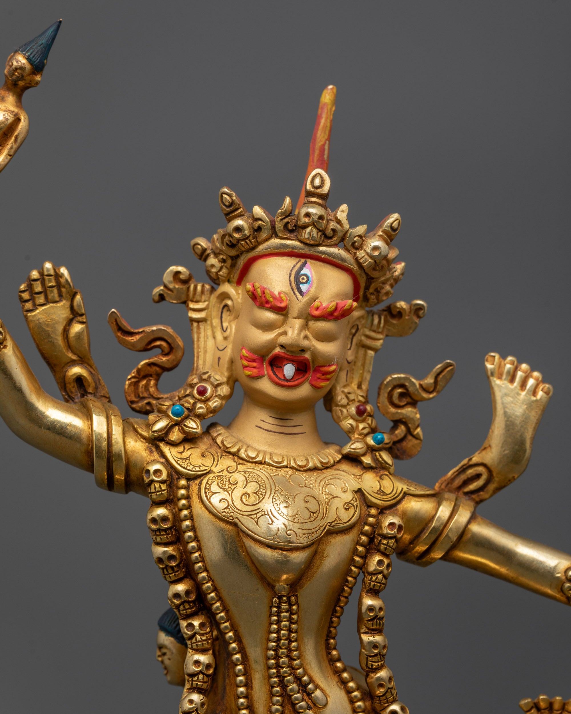 Close up of Ekajati statue showing Five-skull crown garland of skulls and tiger skin skirt
