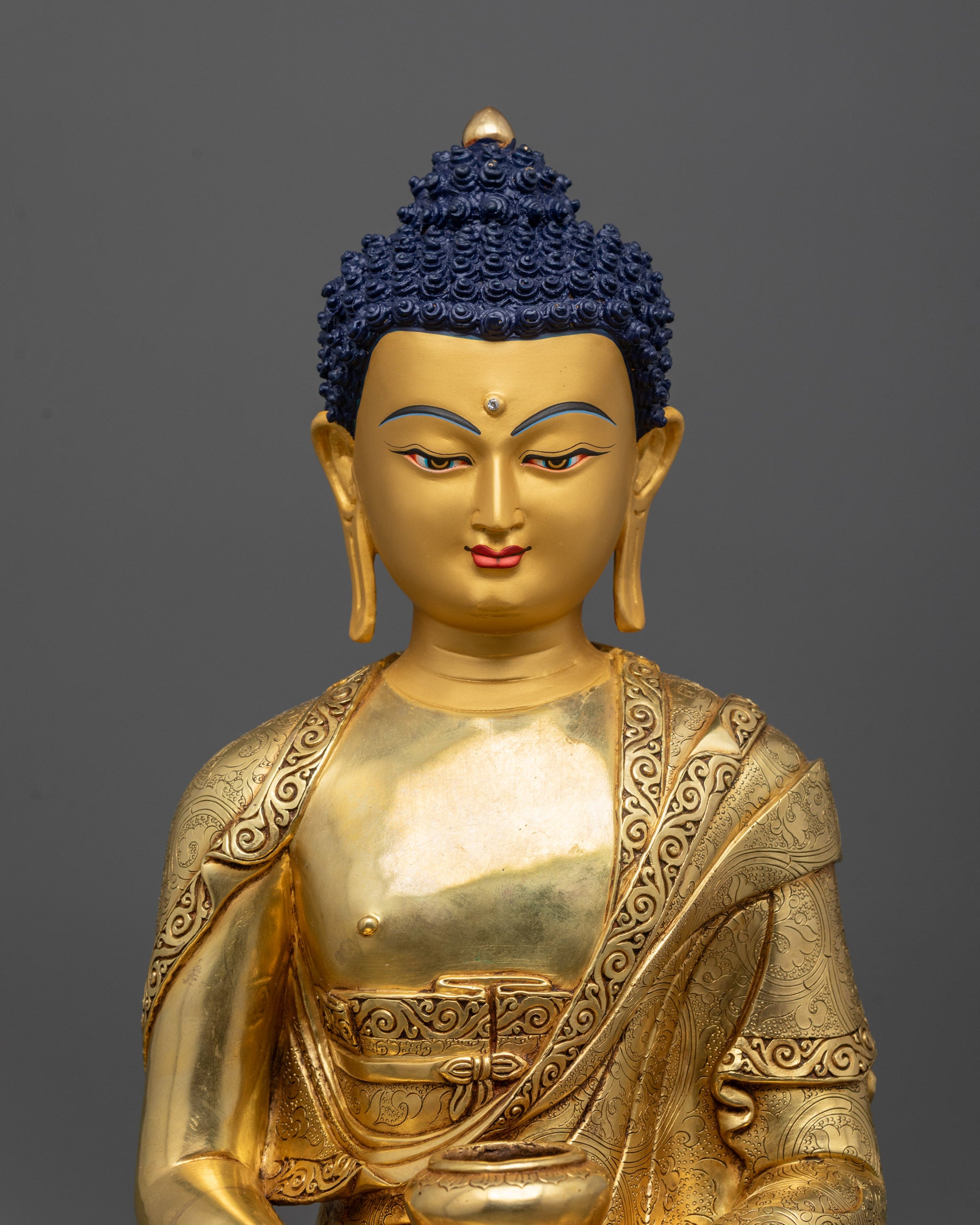 Close up of Eternal Light Buddha showing gold fire-gilded body and intricate carved robe details