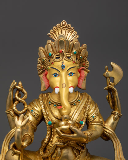 Close up of Ganesha’s gold-gilded face and third eye on forehead