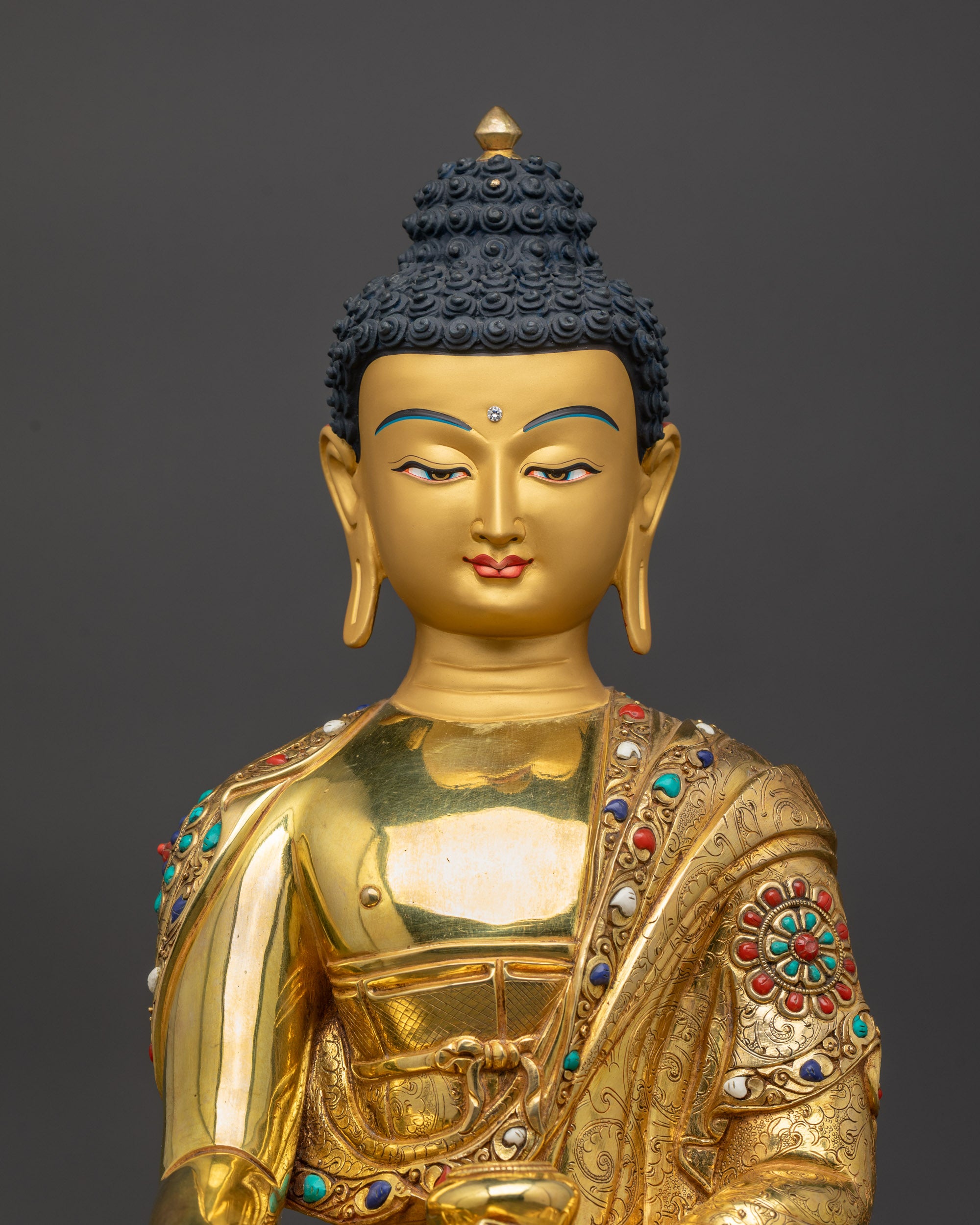 Close up of Gautama Buddha face with peaceful gold-gilded Shakyamuni meditation