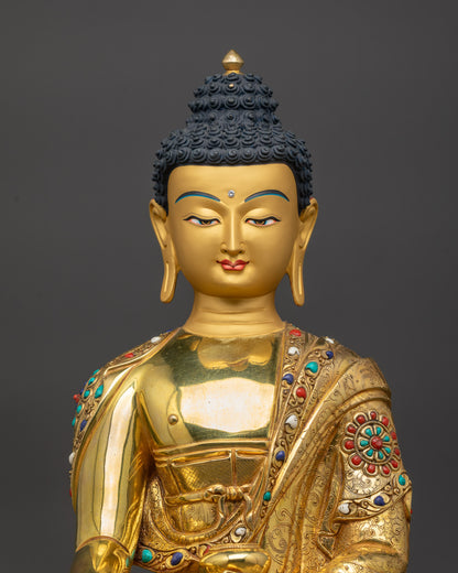 Close up of Gautama Buddha face with peaceful gold-gilded Shakyamuni meditation
