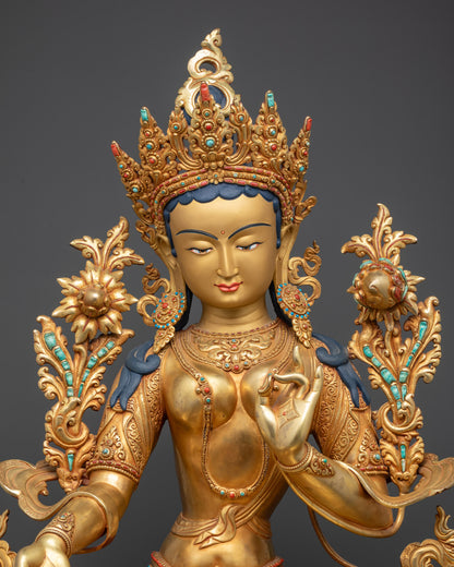Close up of Green Tara Statue highlighting crown, robes, and utpala flower