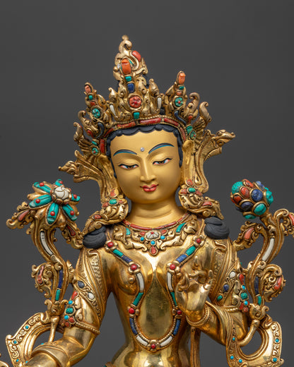 Close up of Green Tara Statue showing five-jeweled crown, utpala flower, and serene expression
