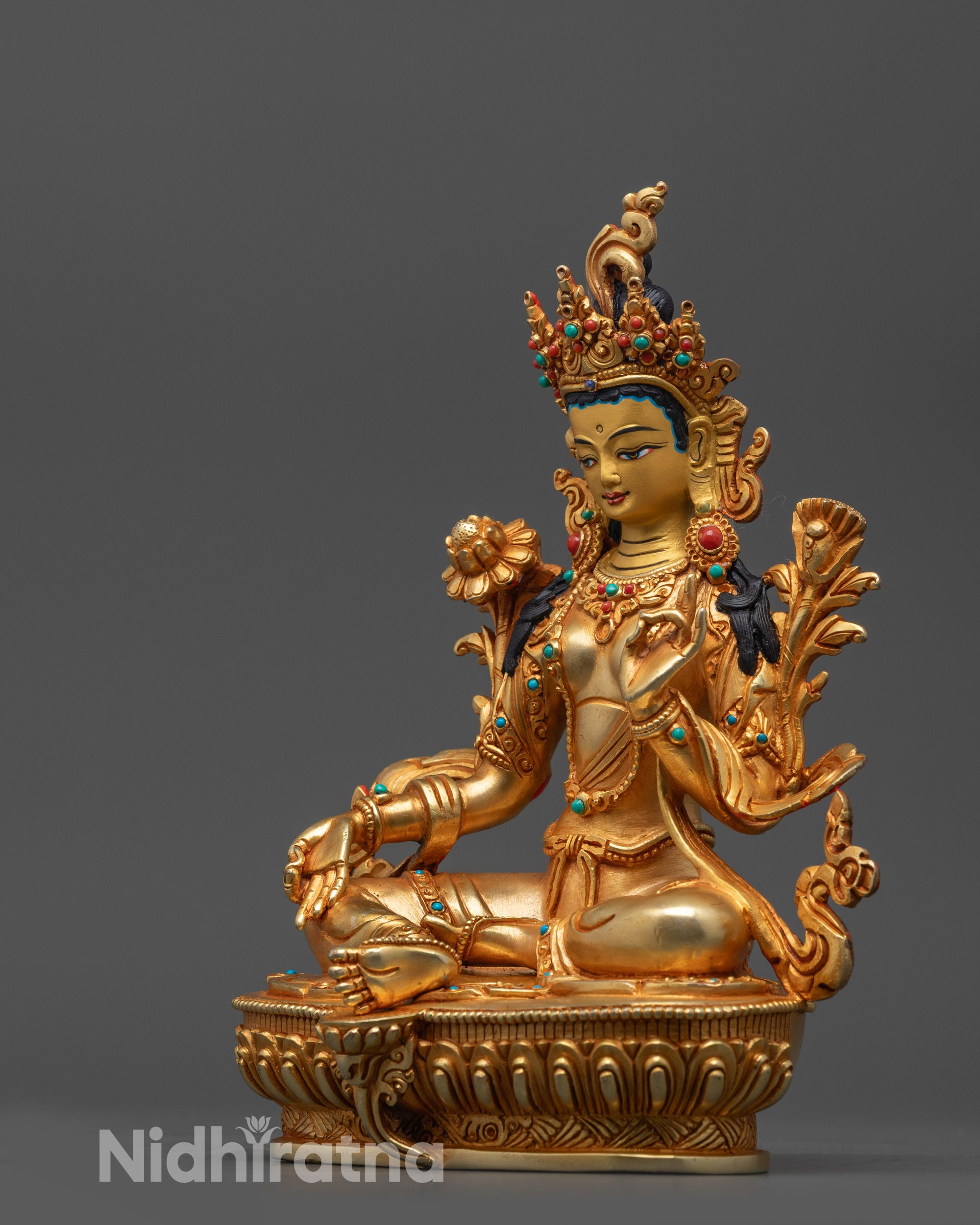 Close up of Green Tara Statue showing utpala flower Vitarka mudra and intricate jewelry