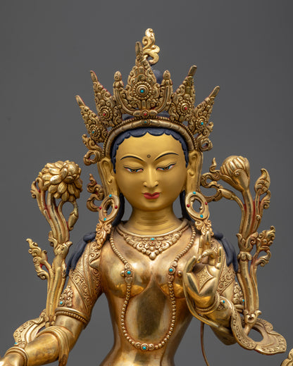 Close up of Green Tara’s gold-gilded face, Five-Jeweled Crown, and semi-precious stones