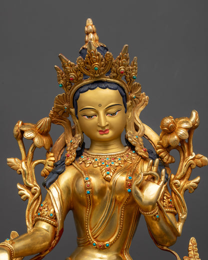 Close up of Green Tara statue face and five-jewel crown showing intricate craftsmanship
