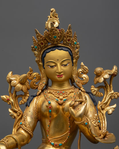 Close up of Green Tara statue showing five-jeweled crown and gemstone-adorned robe
