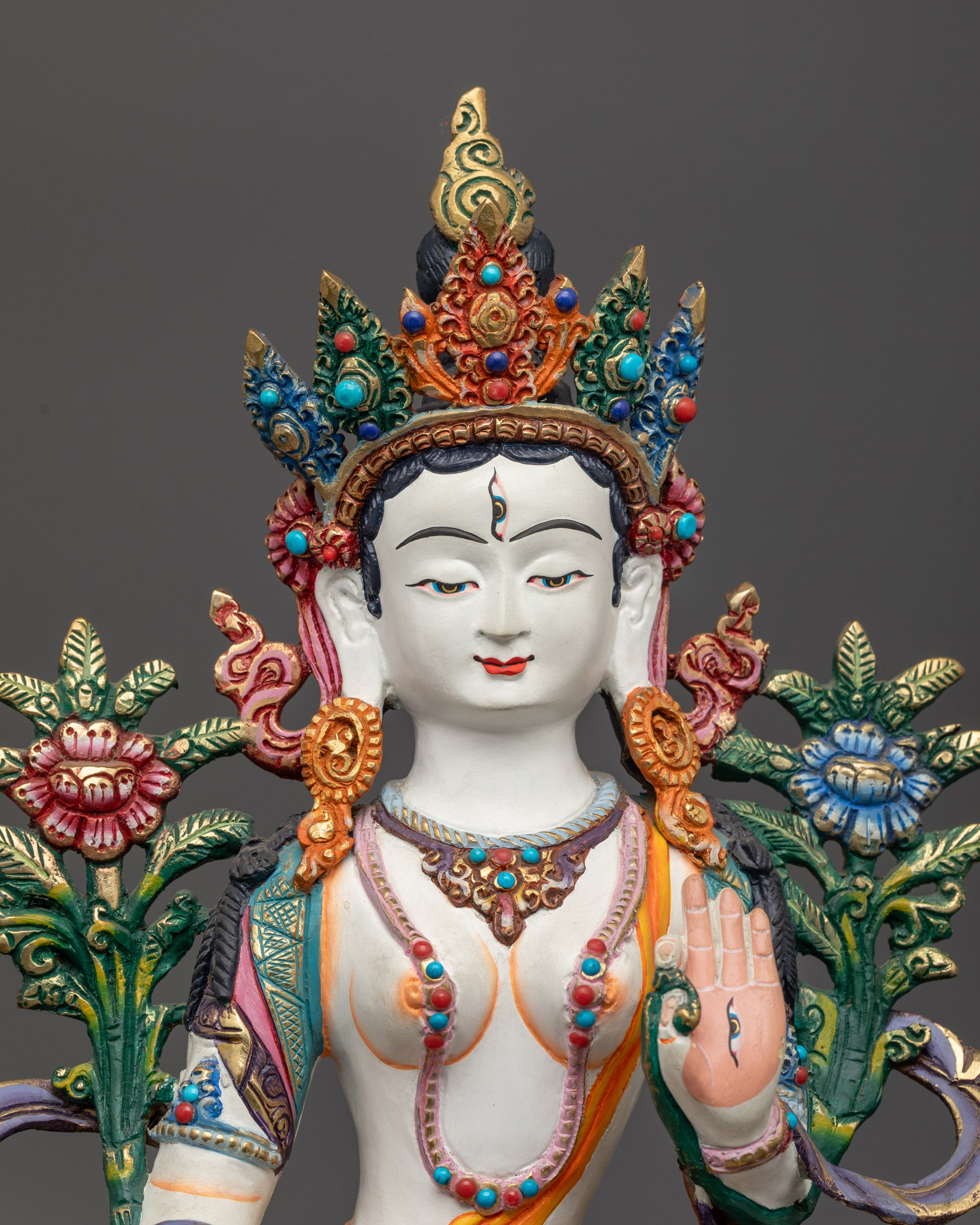 Close up of Jetsun Drolma’s face and seven eyes with jeweled crown details
