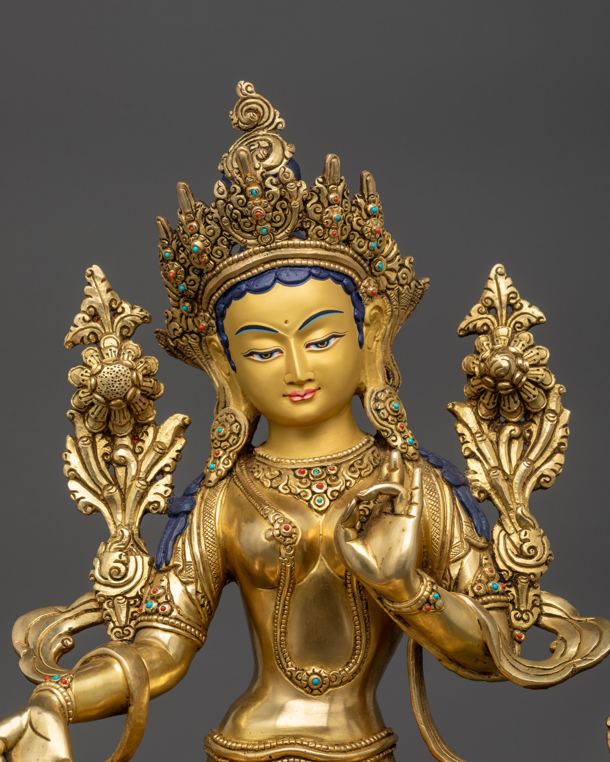 Close up of Jetsun Drolma’s serene gold-gilded face and five-jeweled crown