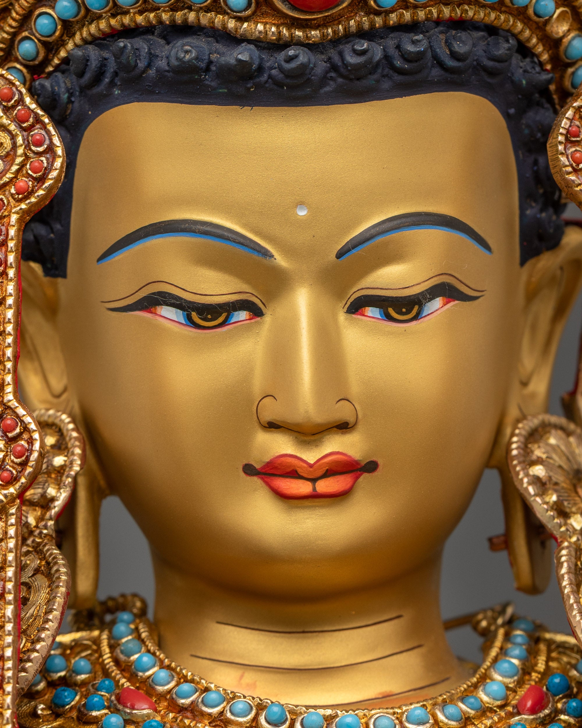 Close up of Jowo Rinpoche Buddha gold-gilded face and semi-precious stones