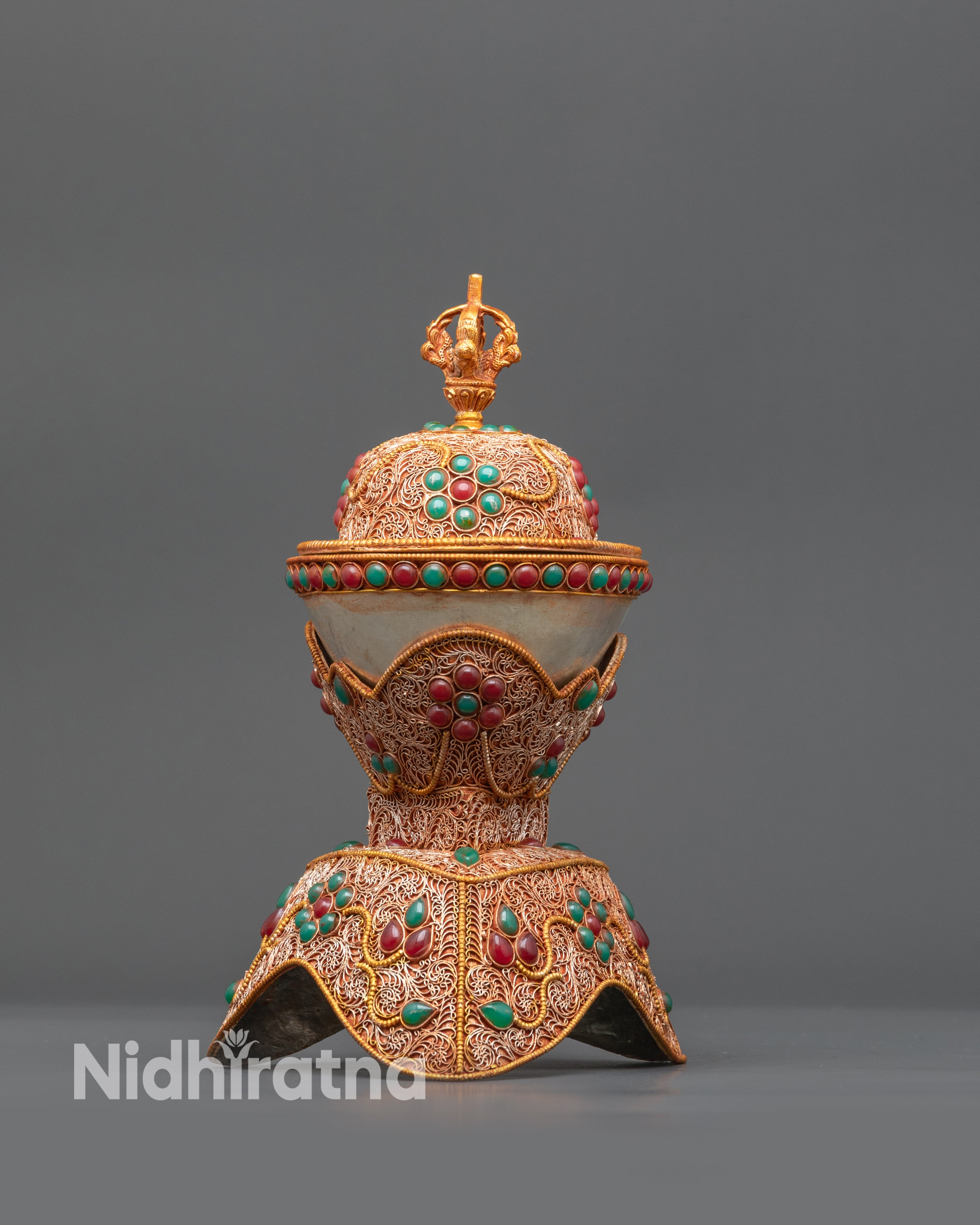 Close up of Kapala showing gold and copper filigree work with semi-precious stones
