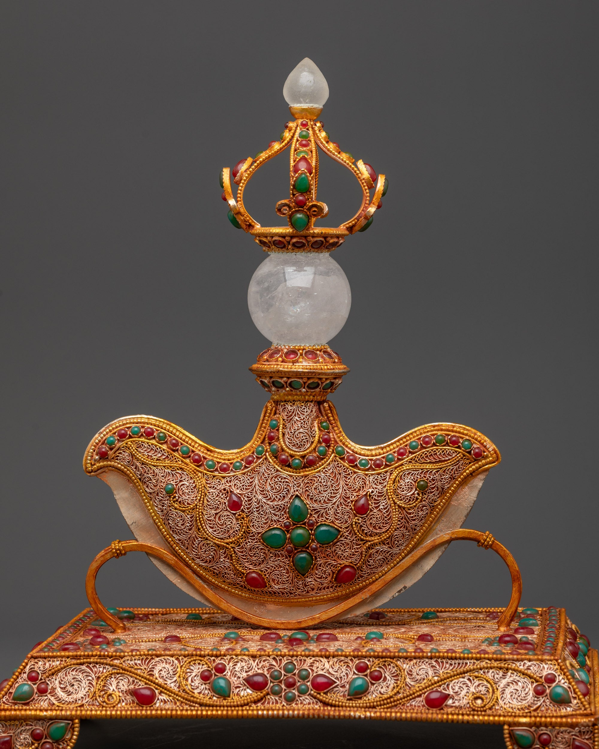 Close up of Kartika dagger showing vajra handle, crystal sphere, and emerald coral stones