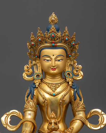Close up of Ksitigarbha statue showing intricate semi-precious stone-adorned robe and crown

