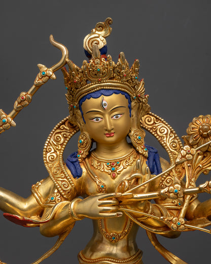 Close up of Kurukulla Statue showing four arms, crown, jewelry, and floral arrow
