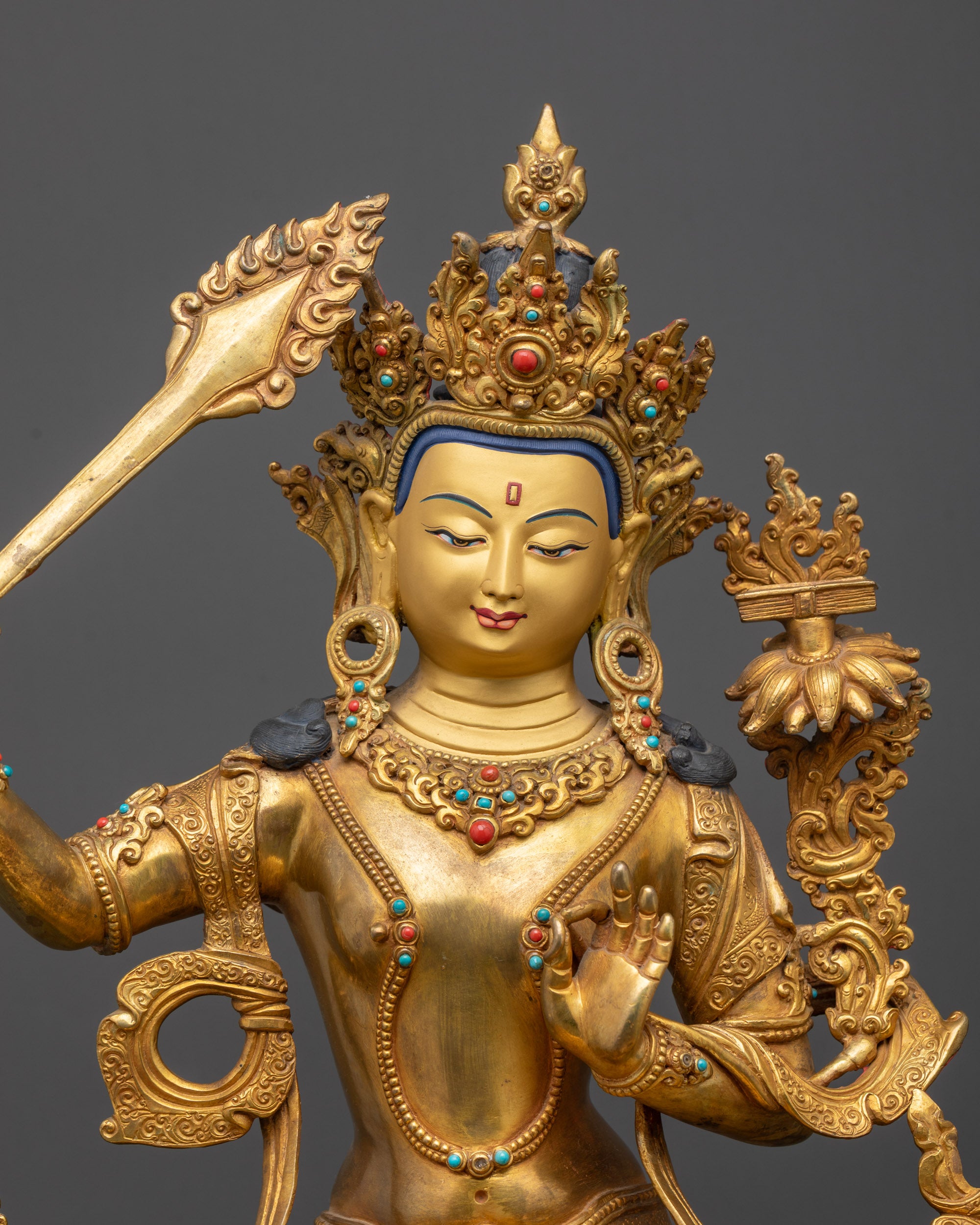 Close up of Manjushri Statue showing intricate robes and wisdom sword details
