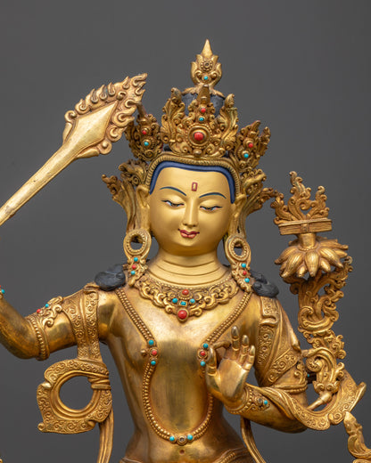 Close up of Manjushri Statue showing intricate robes and wisdom sword details
