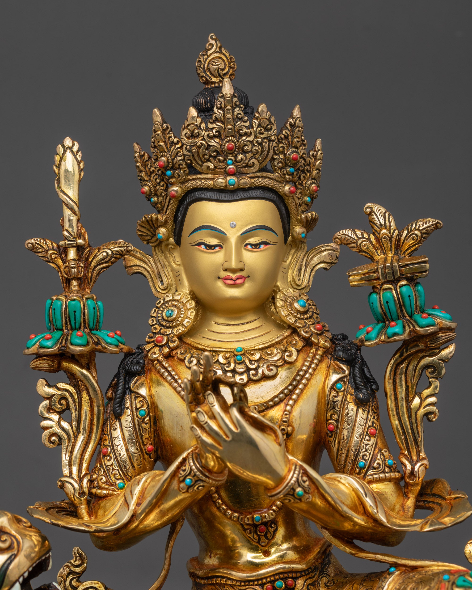 Close up of Manjushri face highlighting serene expression and elaborate earrings
